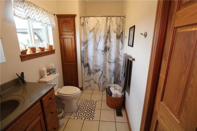 full bathroom featuring toilet, curtained shower, tile patterned flooring, and vanity