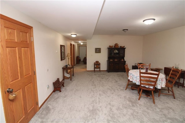 dining area with carpet floors and baseboards