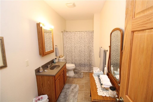 bathroom featuring toilet, tile patterned flooring, and vanity