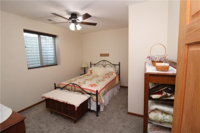 carpeted bedroom featuring baseboards and a ceiling fan