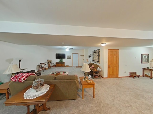 carpeted living room with a ceiling fan and baseboards