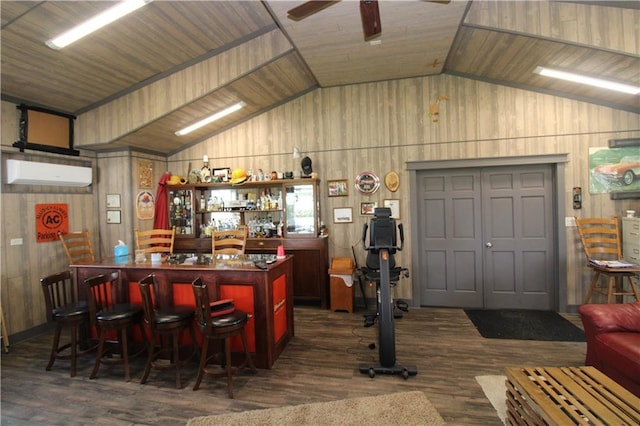 bar featuring lofted ceiling, ceiling fan, dark wood-style flooring, an AC wall unit, and a bar