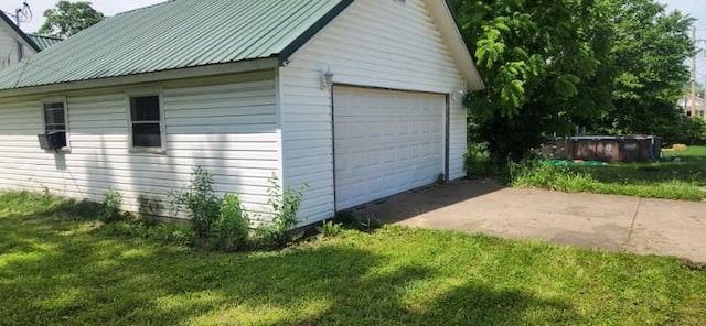 garage featuring a lawn