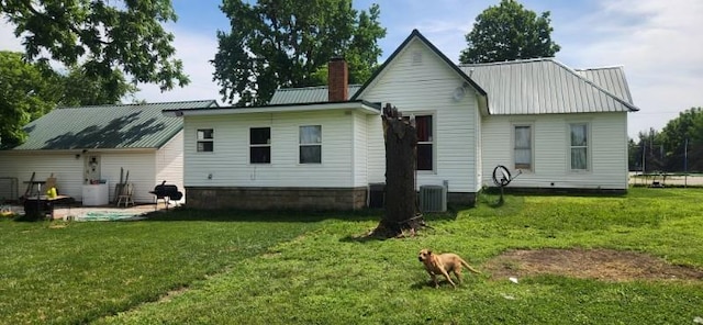 back of house with a yard and central AC unit