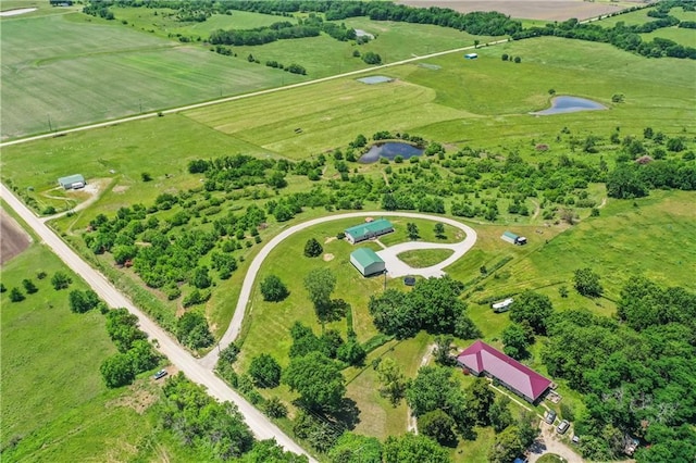 drone / aerial view featuring a water view and a rural view