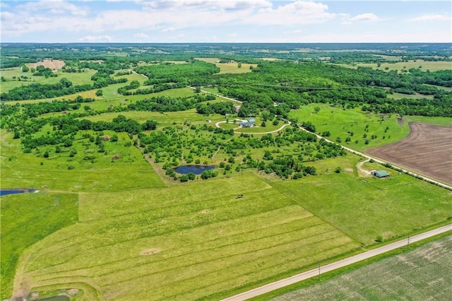 birds eye view of property with a rural view