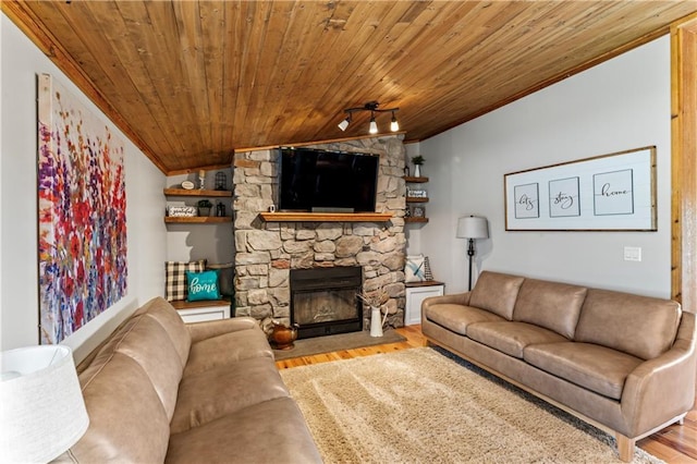 living room with lofted ceiling, wood ceiling, a fireplace, ornamental molding, and light wood-type flooring