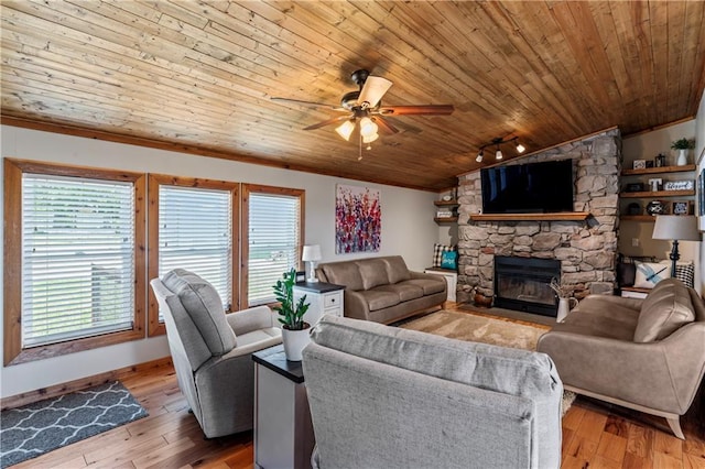 living room featuring vaulted ceiling, light hardwood / wood-style flooring, wooden ceiling, ceiling fan, and a fireplace