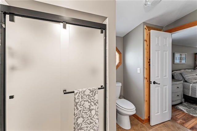 bathroom with wood-type flooring and toilet