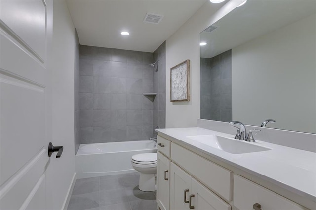 bathroom featuring toilet, vanity, visible vents, tile patterned flooring, and washtub / shower combination