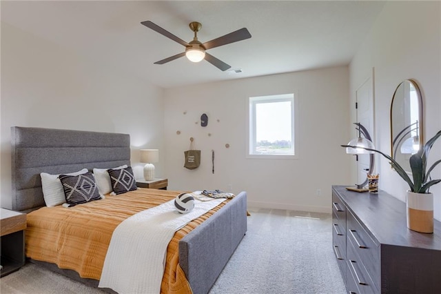 bedroom with ceiling fan, light carpet, baseboards, and visible vents