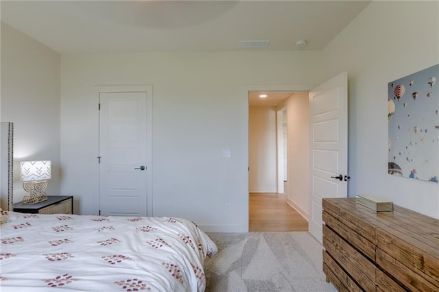 bedroom featuring light colored carpet