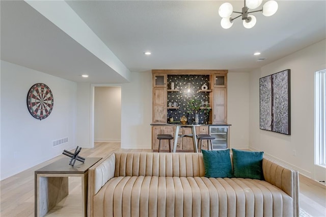 interior space featuring a notable chandelier, light wood-style flooring, recessed lighting, baseboards, and visible vents