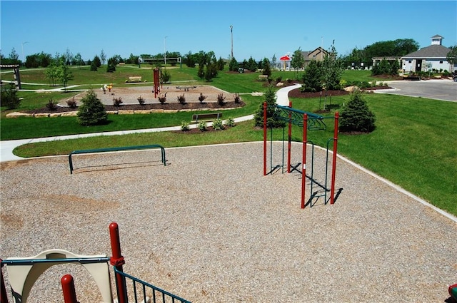 view of property's community with a playground and a yard