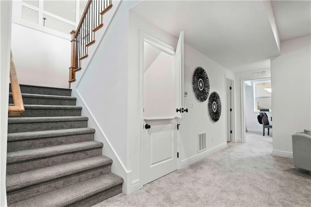 stairs featuring carpet flooring