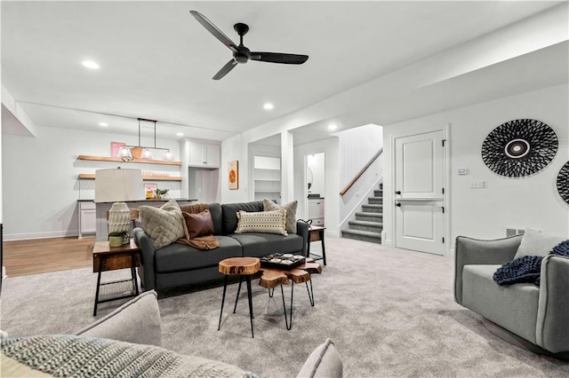 carpeted living room featuring ceiling fan