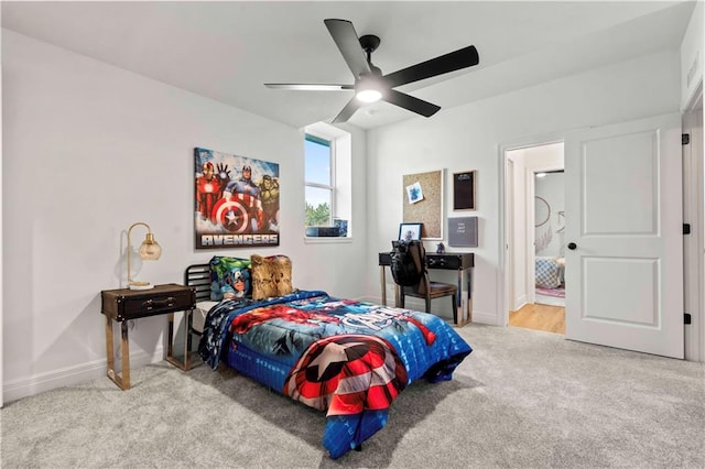 carpeted bedroom with ceiling fan and ensuite bathroom