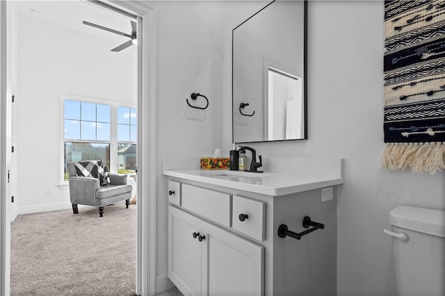 bathroom with toilet, ceiling fan, and vanity