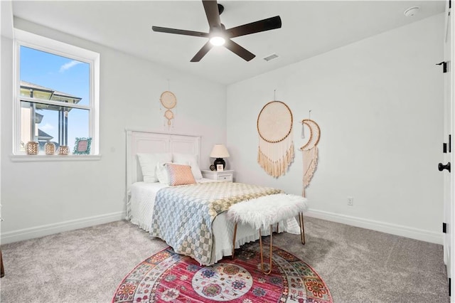 bedroom with ceiling fan and light carpet