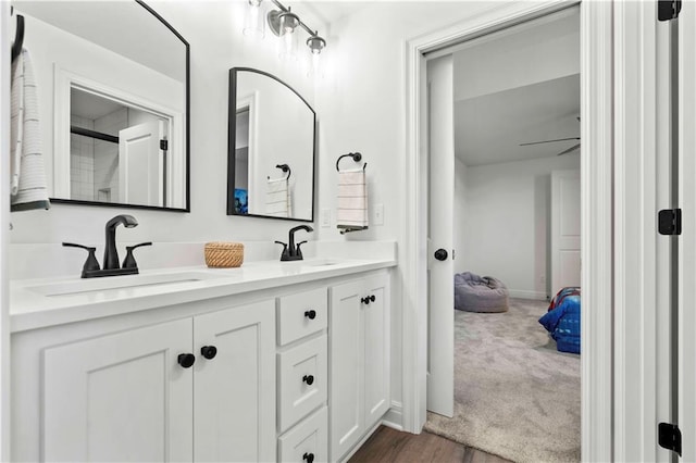 1600 SW 27th St, Lees Summit, MO 64082 - bathroom featuring double vanity, wood finished floors, and a shower