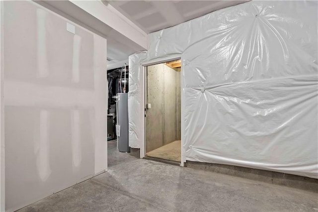 interior space with concrete floors and water heater