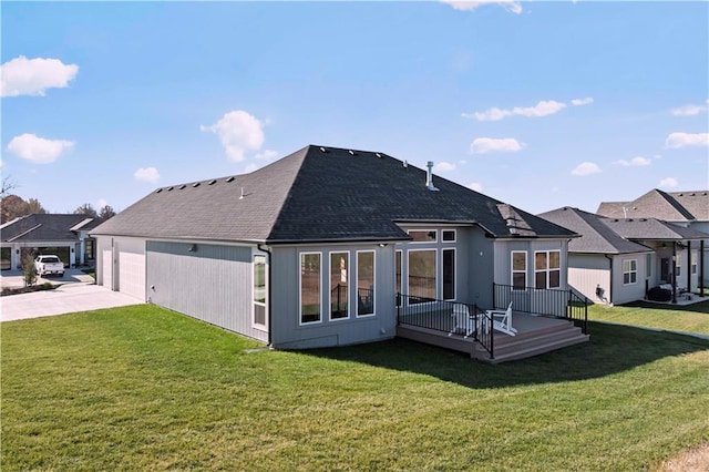 back of house featuring a garage, a wooden deck, and a yard