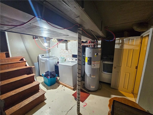 basement with electric water heater and washing machine and clothes dryer