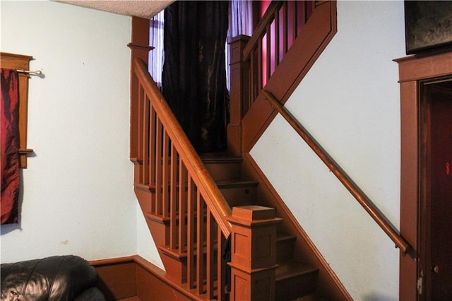 stairway with a textured ceiling