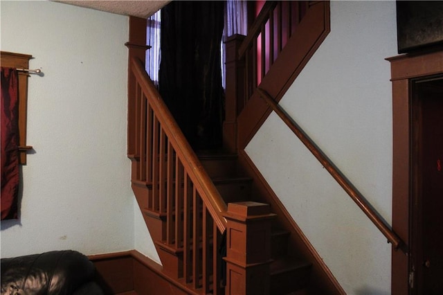 stairway with a textured ceiling