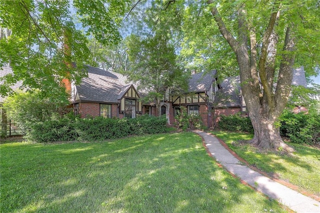 english style home with a front lawn