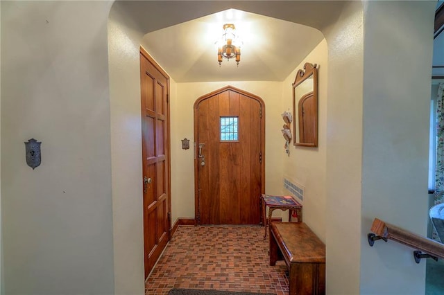 doorway featuring vaulted ceiling