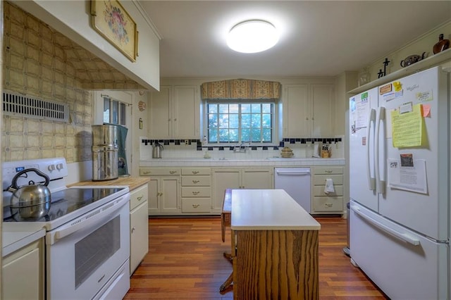 kitchen featuring dark hardwood / wood-style flooring, white cabinets, extractor fan, and white appliances