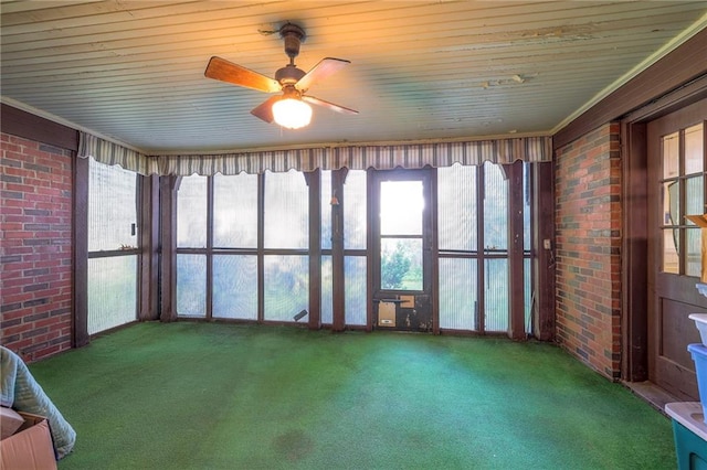 unfurnished sunroom featuring ceiling fan and wood ceiling