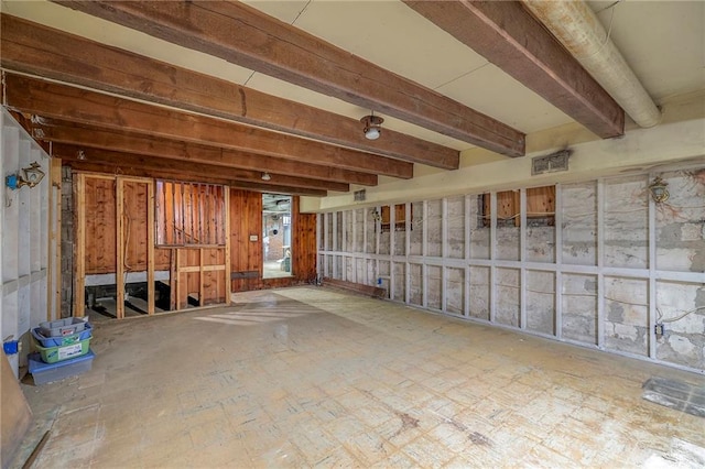 miscellaneous room featuring beam ceiling