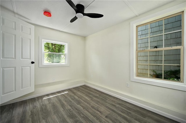 empty room featuring ceiling fan and dark hardwood / wood-style flooring