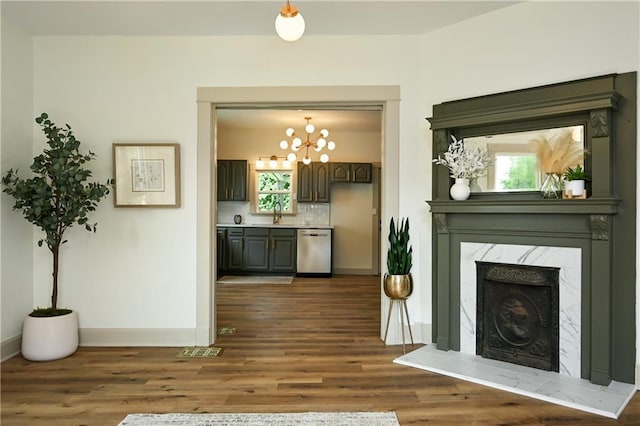 living room featuring dark hardwood / wood-style flooring, sink, and a high end fireplace