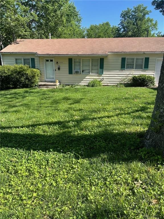 ranch-style home with a front lawn