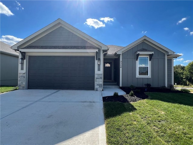 view of front of property featuring a garage and a front lawn