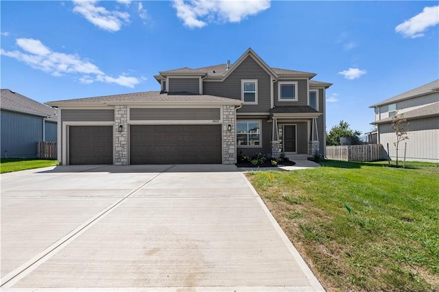 view of front of home featuring a garage and a front lawn