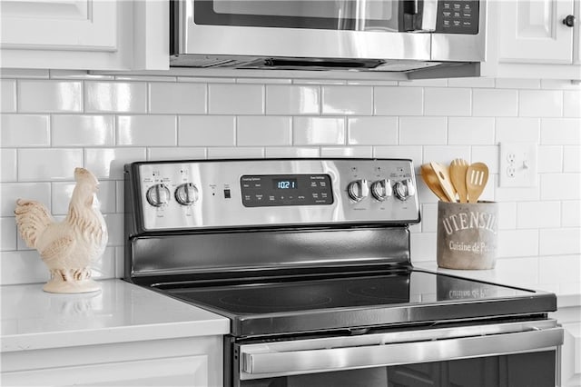 kitchen featuring white cabinetry, decorative backsplash, and appliances with stainless steel finishes