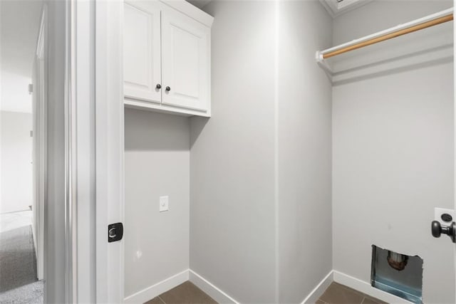 washroom featuring cabinets, dark tile patterned floors, and hookup for an electric dryer