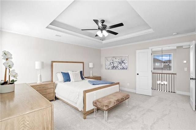 bedroom with a raised ceiling, ornamental molding, carpet flooring, and ceiling fan