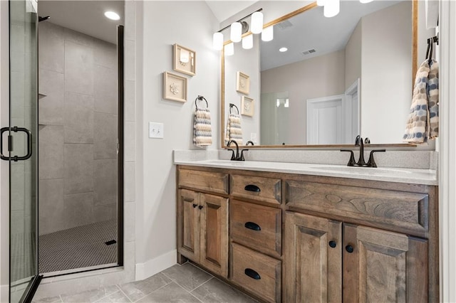 bathroom with vanity and a shower with door