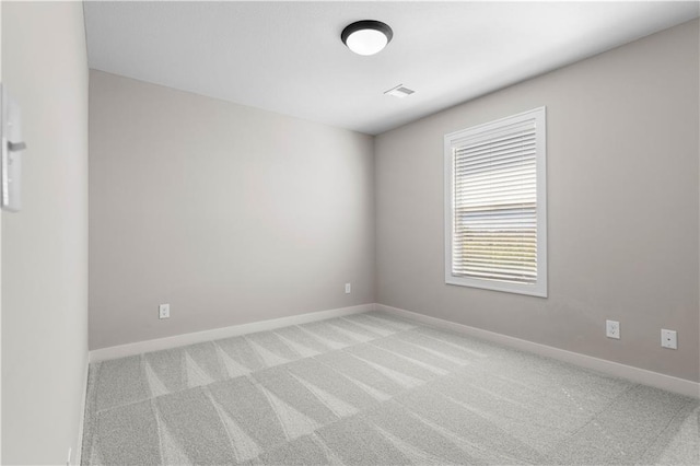 unfurnished room featuring light colored carpet