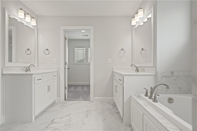 bathroom featuring a washtub and vanity