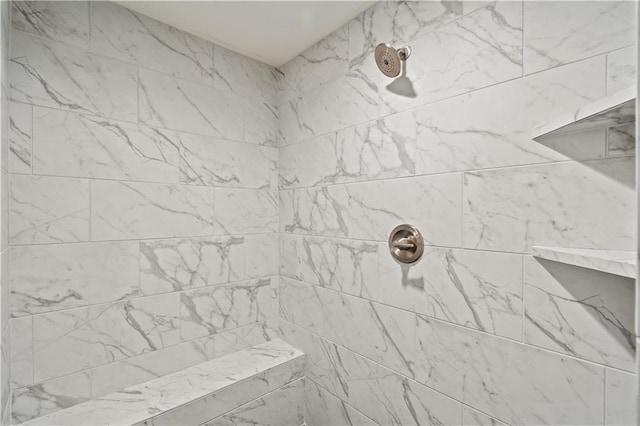 interior details featuring a tile shower