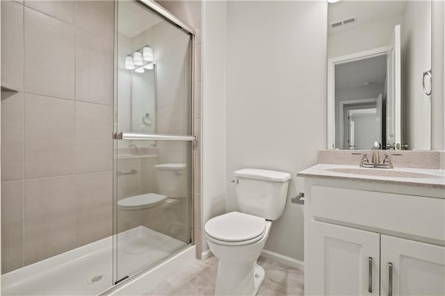 bathroom with an enclosed shower, vanity, and toilet