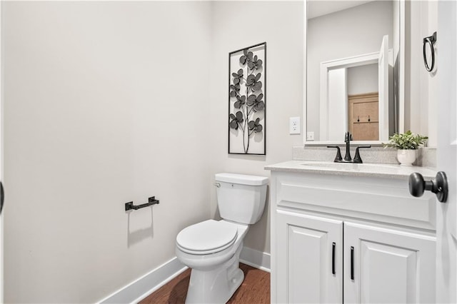 bathroom with vanity, wood-type flooring, and toilet