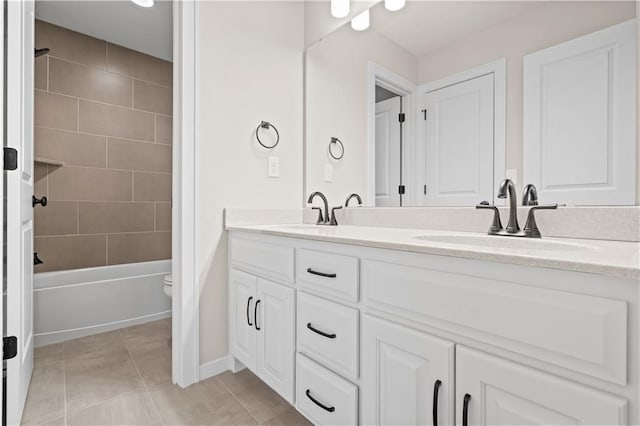 full bathroom featuring tile patterned floors, vanity, toilet, and tiled shower / bath combo