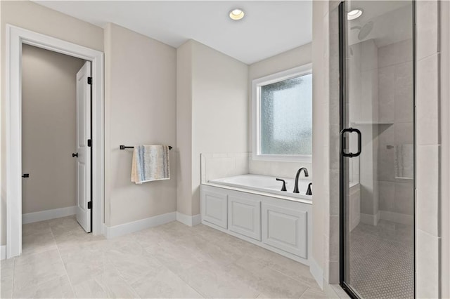 bathroom featuring tile patterned flooring and shower with separate bathtub